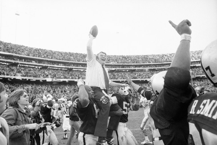 John Madden Holding the Ball High