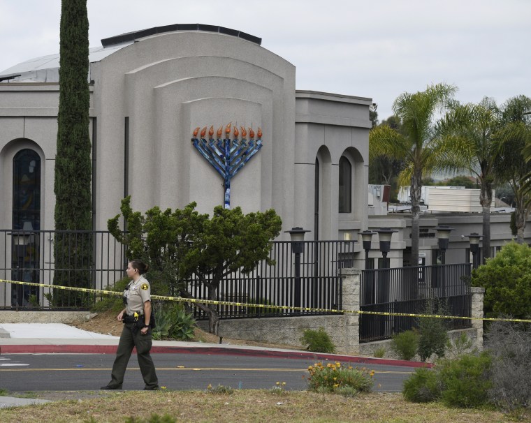 A San Diego County sheriff's deputy stands in front of the Chabad of Poway synagogue, in Poway, California, on April 28,  2019, the day after a woman was killed and three people were injured in a shooting.
