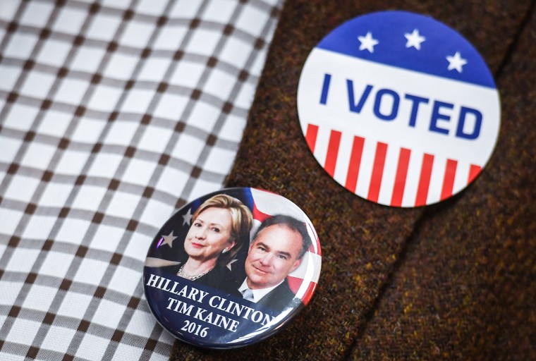 A guest of the election party wears a sticker stating "I Voted" next to a button depicting the democratic candidates Hillary Clinton and Tim Kaine at the U.S. Consulate in Leipzig, Germany, on Nov. 8, 2016.