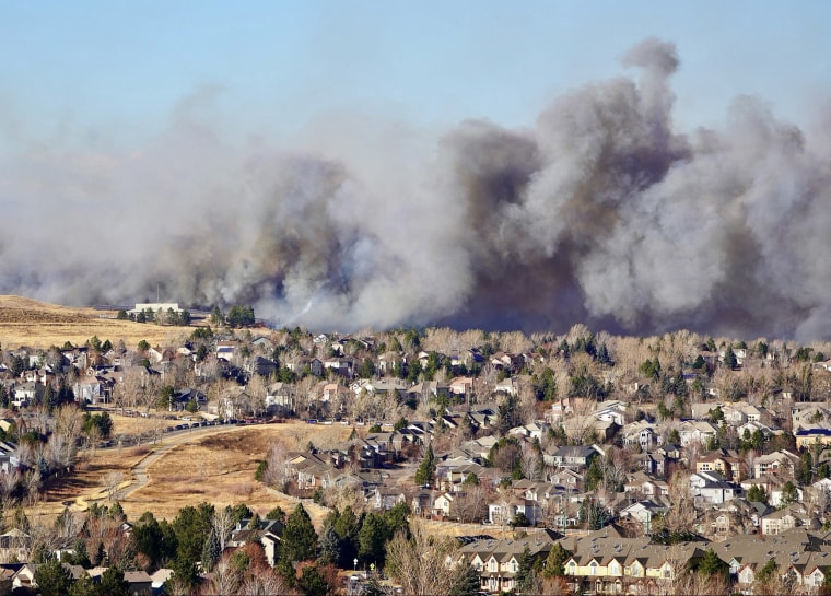 Image: Smoke covers the skyline as a wind-driven wildfire forced evacuation of Superior suburb of Boulder, Colo., on Dec. 30, 2021.