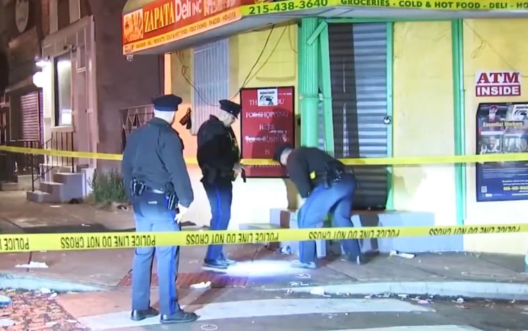 Police investigate the scene of a shooting in Philadelphia late Thursday night.