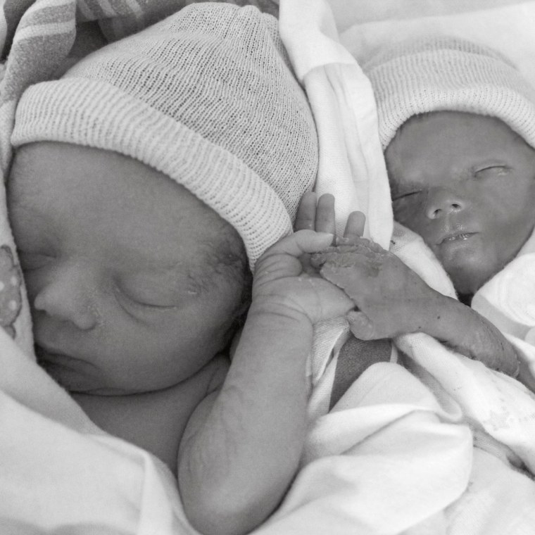 Nicole Collins said she is grateful she had the opportunity to read to her stillborn son, Will, who is pictured here holding his twin brother Asher's hand.