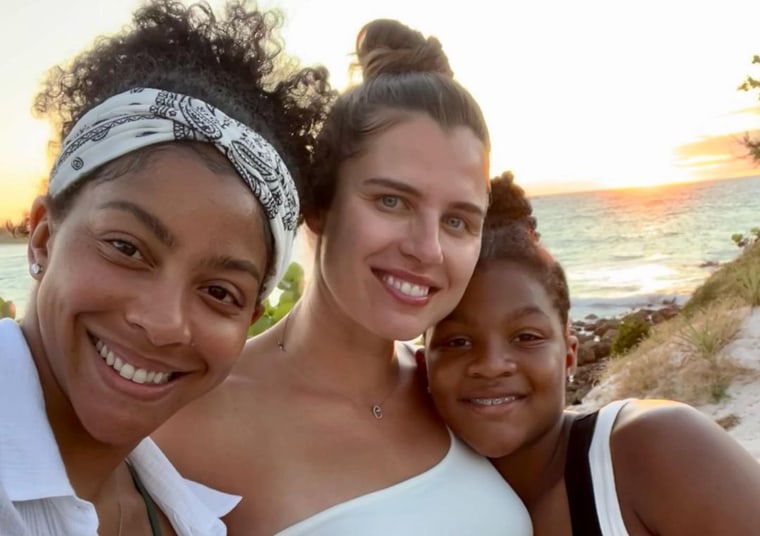 Pro basketball player Candace Parker, left, poses with wife Anna Petrakova and daughter Lailaa in a photo she posted to Instagram to announce that she and Petrakova are expecting their first child together.