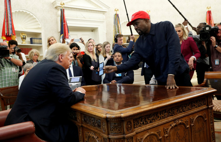 El rapero Kanye West muestra su celular al entonces presidente Donald Trump durante una reunión en la Casa Blanca en octubre de 2018.