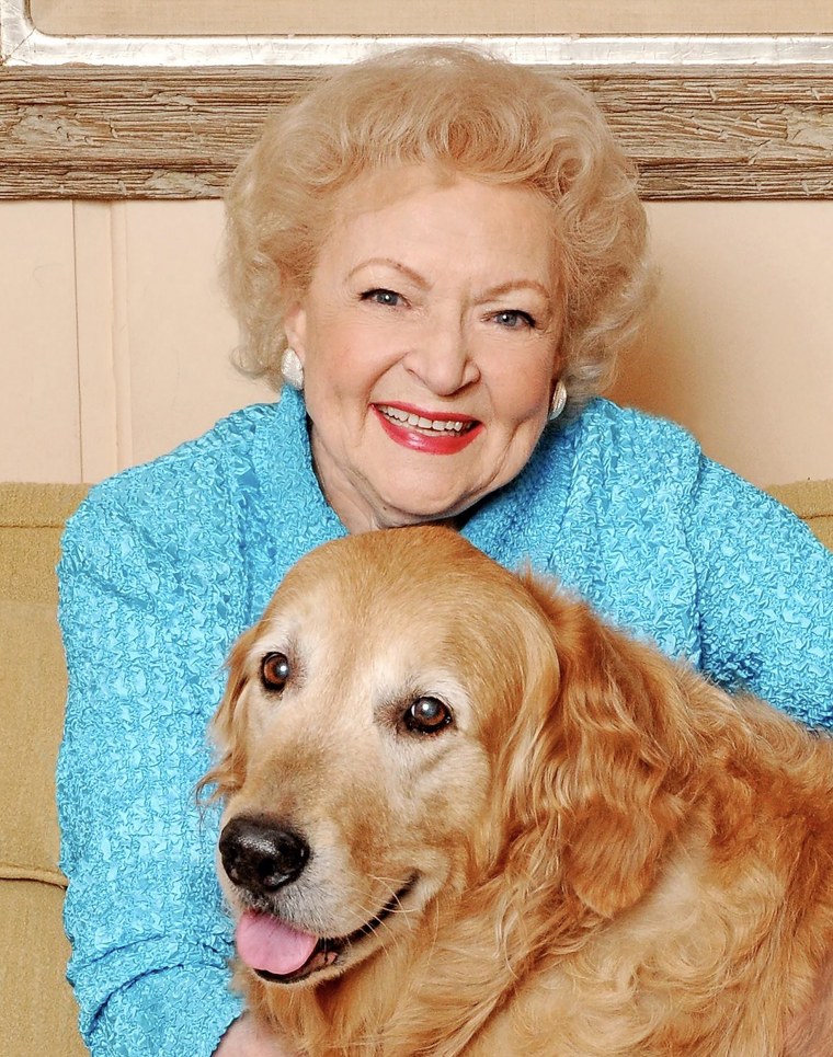 Betty White hugs Pontiac, a golden retriever she acquired from Guide Dogs for the Blind in 2005.