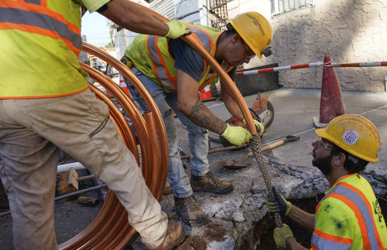 Los trabajadores se preparan para reemplazar las viejas tuberías de agua por una nueva de cobre en Newark, Nueva Jersey, el jueves 21 de octubre de 2021.