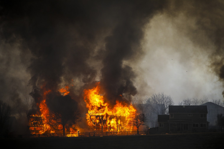 Two homes burn during a wildfire in the Centennial Heights neighborhood.