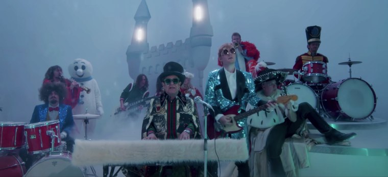 Elton John and Ed Sheeran dress up as rockstars in their "Merry Christmas" music video.