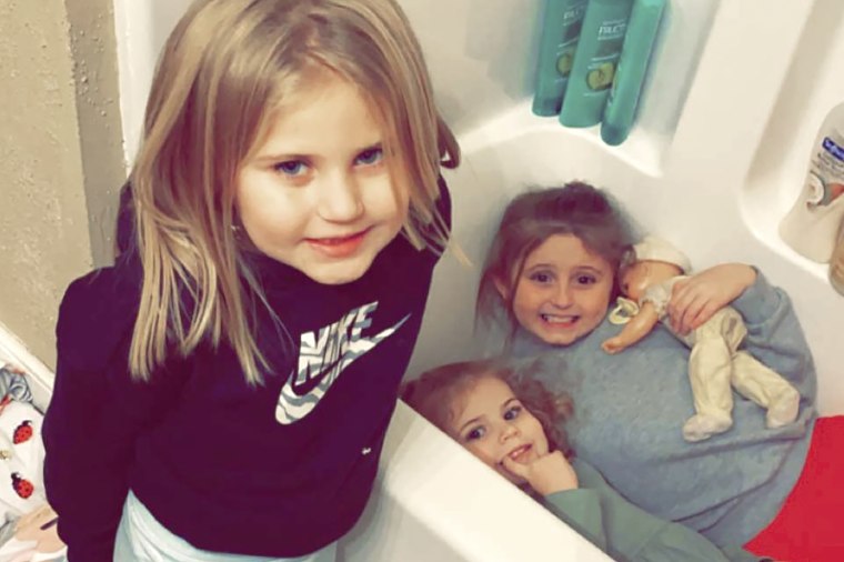 In this Dec. 10, 2021, photo provided by Sandra Hooker, from left, Avalinn Rackley, 7, Alanna Rackley, 3, and Annistyn Rackley, 9, pose for a picture in a bathroom in their home near Caruthersville, Missouri. Annistyn, a third-grader who loved swimming, dancing and cheerleading, was among dozens of people who died because of the severe storm on Friday, Dec. 10.