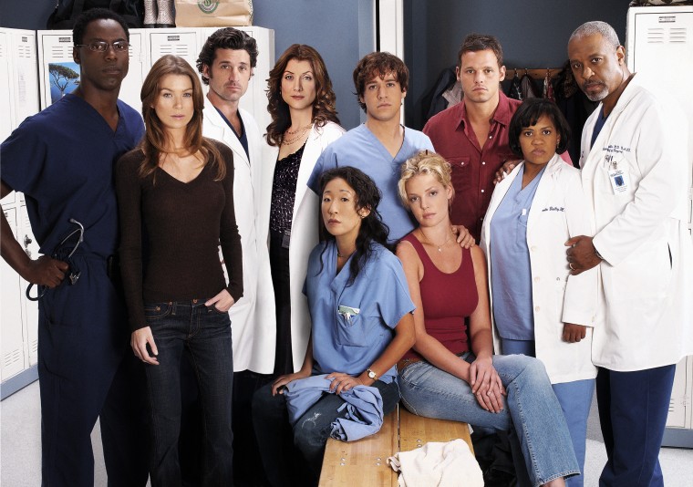 Ellen Pompeo and Patrick Dempsey pose for a cast portrait with their "Grey's Anatomy" co-stars.