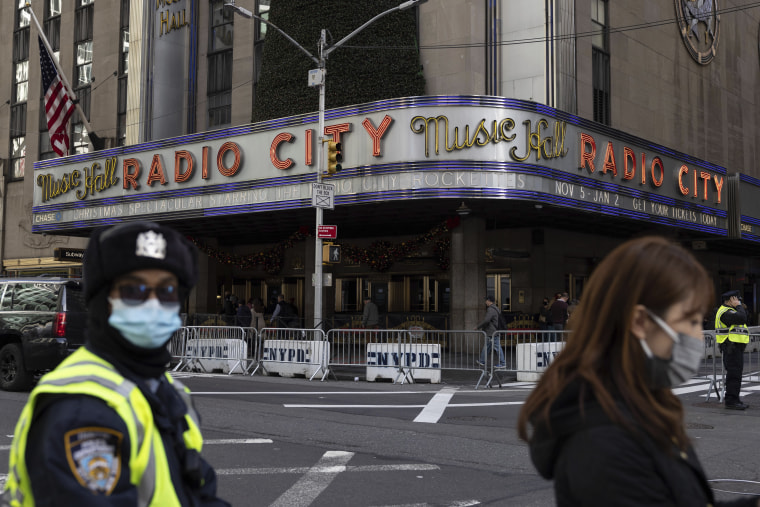 People stand in front of the iconic Radio City Music Hall in New York City