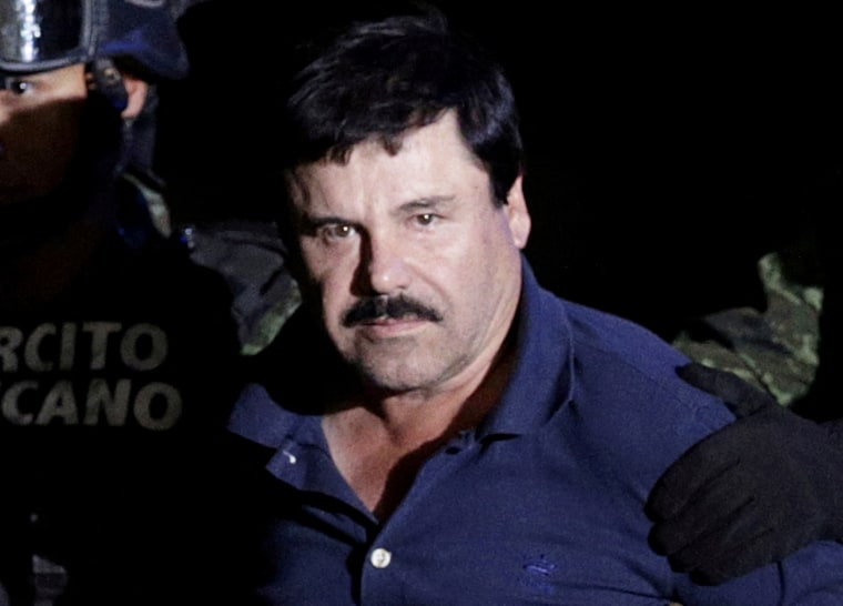 FILE PHOTO: FILE PHOTO: Recaptured drug lord Joaquin "El Chapo" Guzman is escorted by soldiers at the hangar belonging to the office of the Attorney General in Mexico City