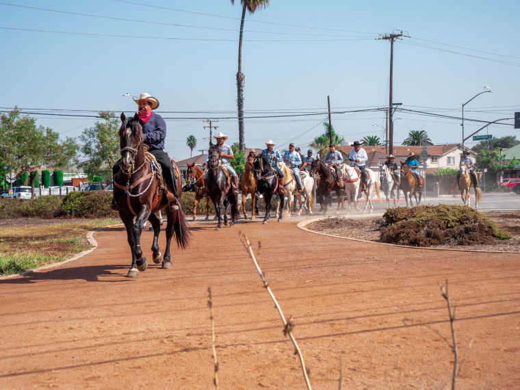 Vaqueros ride through Greenleaf Park before joining hundreds more for a cabalgata on Sept. 20, 2020.