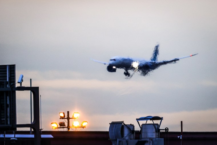 A passenger plane prepares to land at Newark International Airport in New Jersey on Dec. 27, 2021.