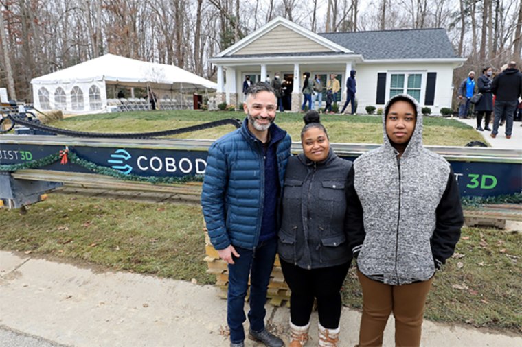 Image: Alquist 3D CEO Zach Mannheimer with new Habitat for Humanity homeowner April in front of her 3D printed home in Williamsburg, Virginia.