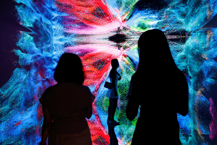 Image: Visitors are pictured in front of an art installation which will be converted into NFT and auctioned online at Sotheby's, in Hong Kong