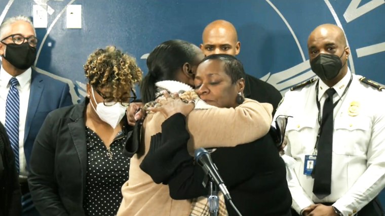 Acquanellia Smith, Nacole Smith's rother, center right, hugs Betty Brown at a press conference in Atlanta on Jan. 4, 2022. Police had solved the 1995 cold case of Nacole's murder through DNA technology. The suspect was also linked to the 2004 rape of Brown.