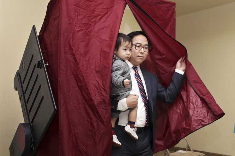 Then-candidate Andy Kim holds his son as he finishes voting onNov. 6, 2018, in Bordentown, N.J.
