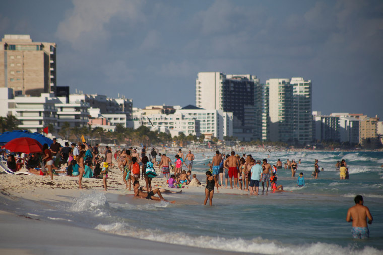 Beachgoers in Cancun, Mexico, on Dec. 27, 2021.