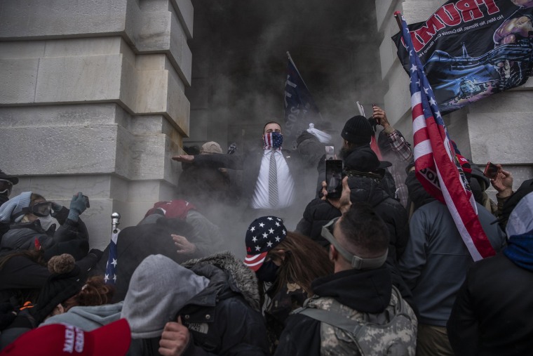 Image: Demonstrators attempt to breach the Capitol after they had stormed the building on Jan. 6, 2021.