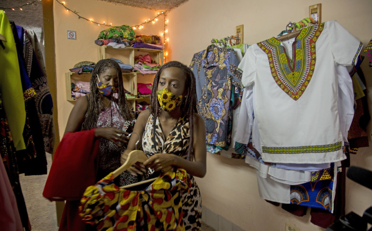 Image: Yurena Manfugas Terry, front, and her mother Deyni Terry Abreu, behind, are business partners in an Afro clothing brand in Havana, Cuba.