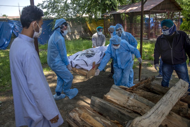 Relatives and volunteers carry the body of a Covid victim at a crematorium in Srinagar, Indian, controlled Kashmir, last May. 