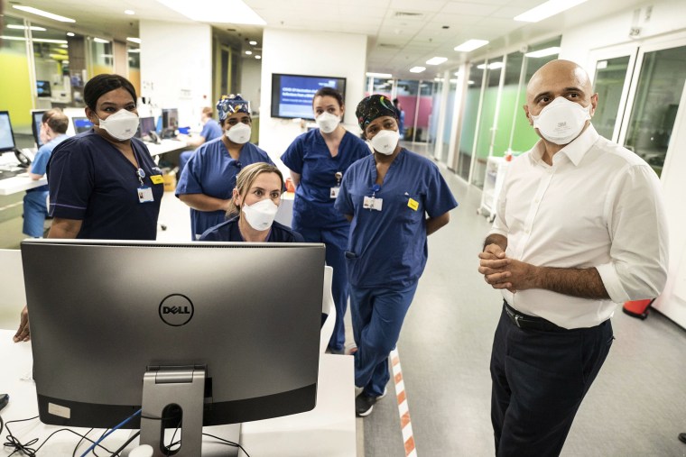 Britain's Health Secretary Sajid Javid, right, meets staff in a Covid-19 Intensive Care Unit during a visit to Kings College Hospital in London on Jan. 7, 2022.