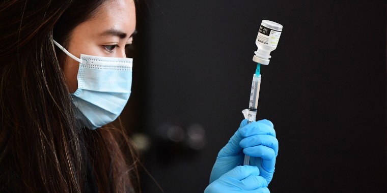 A vial of Covid-19 vaccine is prepared