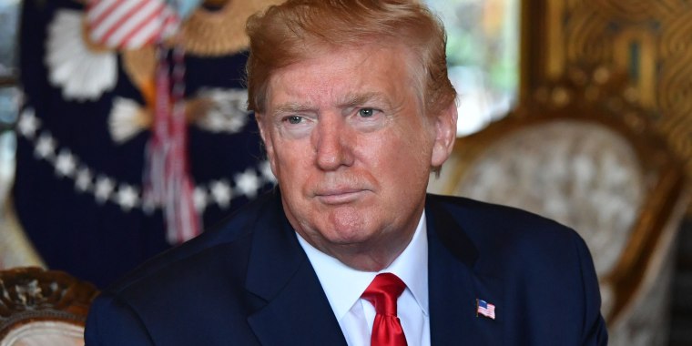 Then-President Donald Trump answers questions from reporters on Dec. 24, 2019.