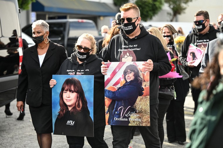 Image: Soledad Peralta and Juan Pablo Orellana Larenas, parents of 14-year-old Valentina Orellana-Peralta, carry photos of their daughter as they follow her casket during her funeral, Jan. 10, 2022 at City of Refuge Church in Gardena, Calif.