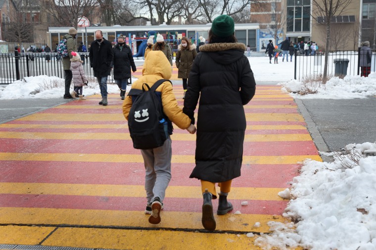 Students arrive for classes at A. N. Pritzker elementary school on January 12, 2022, in Chicago.