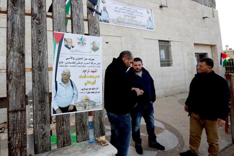 Image: Men stand next to a poster of Palestinian Omar Abdalmajeed As'ad, 80, in Jiljilya village in the Israeli-occupied West Bank