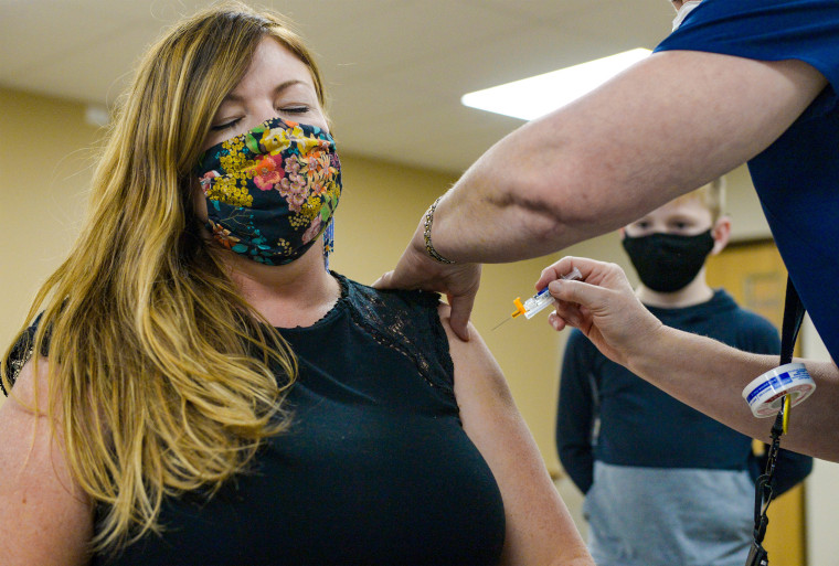 Kristi Scott receives a flu vaccination at Great Falls College in Great Falls, Mont., on Nov. 16.