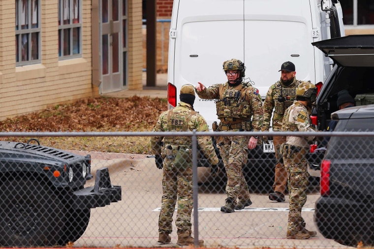 SWAT team members deploy near the Congregation Beth Israel Synagogue in Colleyville, Texas, on Jan. 15, 2022.