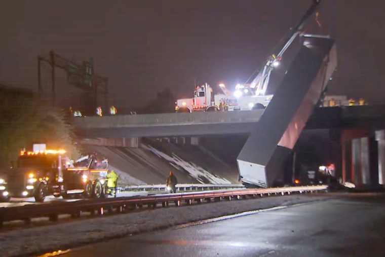 A tractor-trailer slid off the N.C. Highway 147 bridge in Durham late Sunday. 