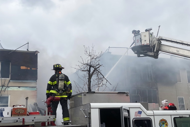 Firefighters work to put out a fire in the Bronx, N.Y., on Jan. 18, 2022.