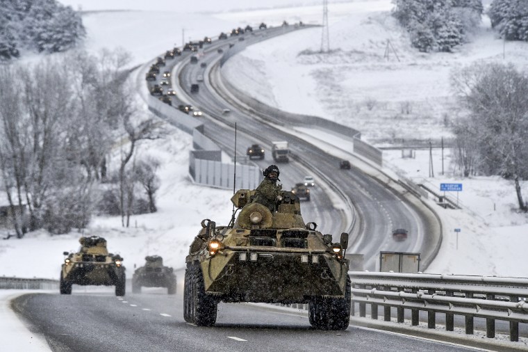 Image: A convoy of Russian armored vehicles moves along a highway in Crimea, on Jan. 18, 2022.