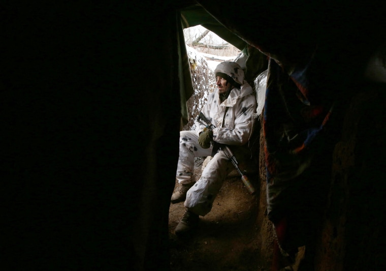 A Ukrainian Military Forces serviceman sits in a trench on the frontline with Russia-backed separatists near Verkhnetoretske village in the Donetsk region on Jan. 18, 2022.