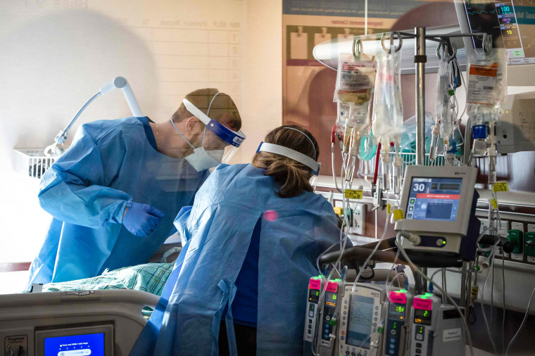 Image: Medical workers treat a patient who is suffering from the effects of Covid-19 in the ICU at Hartford Hospital in Hartford, Conn., on Jan. 18, 2022.