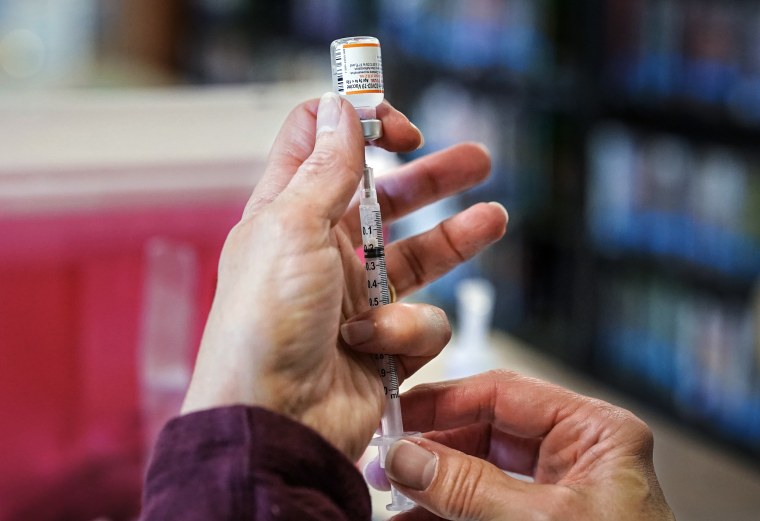 A nurse with Northern Light Health fills a syringe with a Pfizer Covid-19 vaccine dose at a vaccine clinic at Memorial Middle School in South Portland, Me., on Nov. 19, 2021.