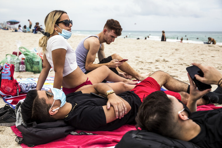 Image: Beachgoers relax on South Beach in Miami on June 19, 2020.