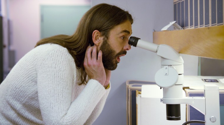 Jonathan Van Ness looks through a microscope in the fourth episode of Netflix's "Getting Curious with Jonathan Van Ness."