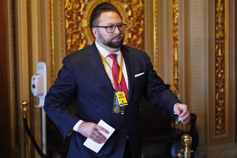 Jason Miller, senior adviser to the Trump 2020 re-election campaign, walks in the Capitol during the second impeachment trial of former President Donald Trump in the Senate on Feb. 9, 2021. 