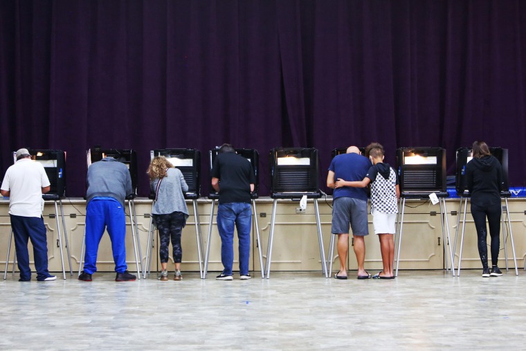 Image: Voters fill in their ballots in Miami Shores on Nov. 3, 2020.