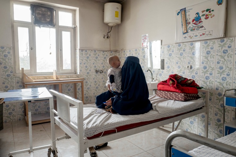 Fatima, an Afghan mother who goes by only one name, caring for her 10-month-old daughter Salma in Maidan Shahr Hospital’s acute-malnutrition ward.