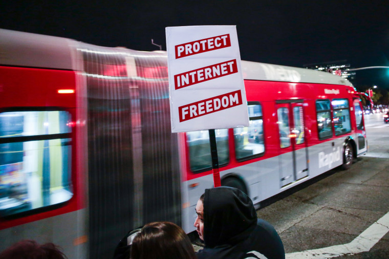 Image: A supporter of Net Neutrality protests the FCC's recent decision to repeal the program in Los Angeles
