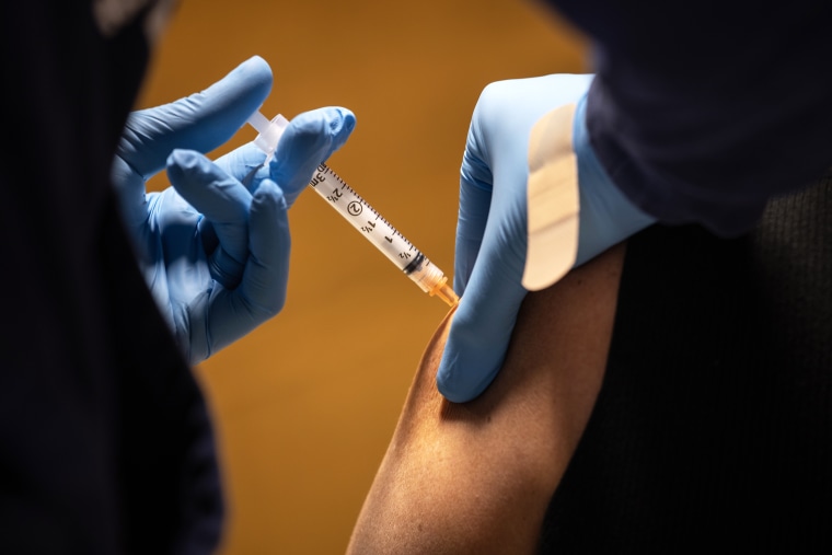 A health worker administers a dose of the Moderna Covid-19 vaccine in Stamford, Conn., on March 14, 2021.