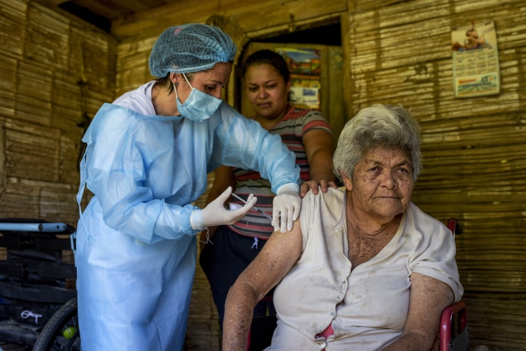 A health worker administers a second dose of the Novavax vaccine on April 8, 2021 in Chaguani, Colombia.
