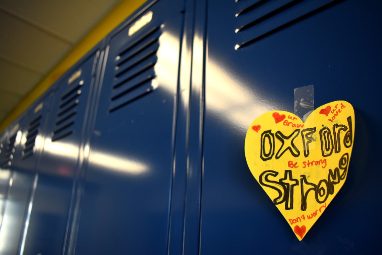 A yellow heart with "Oxford Strong" written in children's handwriting is taped to a blue locker.