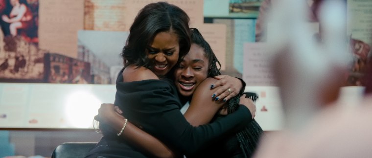 Michelle shares a hug in her documentary "Becoming."
